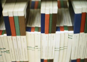 Paperbound journals on a library shelf