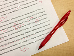 draft of a typed paper with red markings throughout