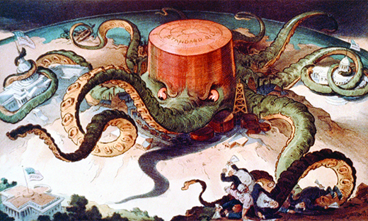 Un dessin animé montre une énorme pieuvre étiquetée « Standard Oil ». Les tentacules de la pieuvre entourent une série de petits bâtiments et structures, ce qui indique qu'elle contrôle les industries de l'acier, du cuivre et du transport maritime, le Capitole américain et une maison de l'État. Un dernier tentacule cherche la Maison Blanche, mais ne l'a pas encore atteinte.