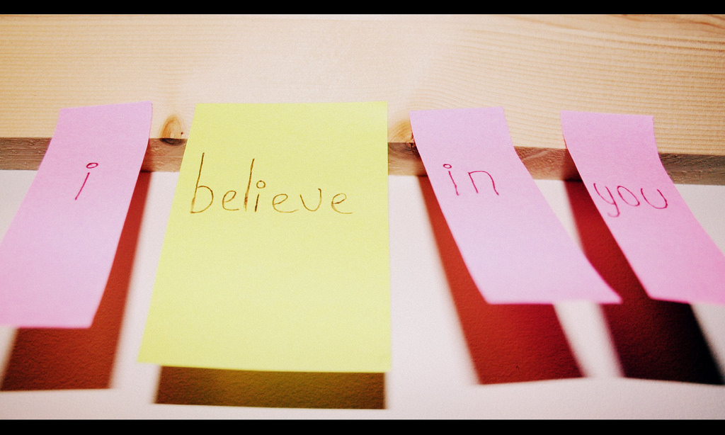 Photograph of four post it notes reading: I believe in you