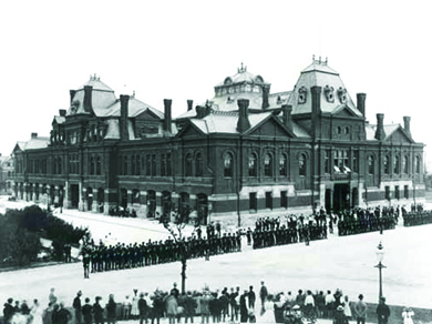 A photograph shows a long line of strikers facing a long line of Illinois National Guardsmen in front of a railroad building.