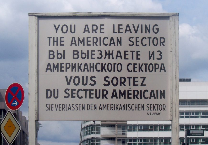 The sign at Checkpoint Charlie, between the American and Soviet sectors (East and West Berlin), photographed 2005 (photo: Henry Robbert, CC0)