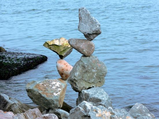 Rocks balanced precariously on beach
