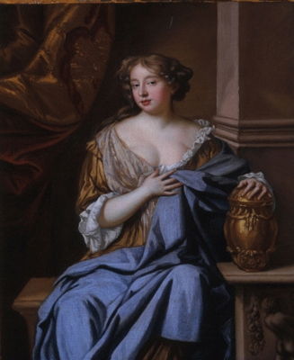 A woman sitting with a brown gown holding a blue blanket