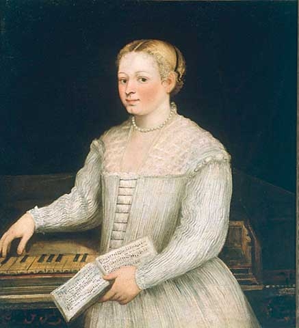 A women in a white dress with a music book in her hand playing a spinet.