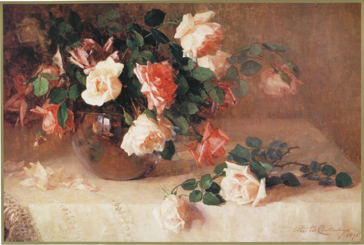 Roses in a clear vase on a white table cloth