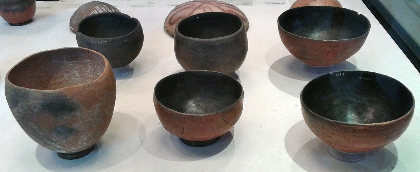 Nubian pottery bowls in different circular sizes mostly in brown and black.