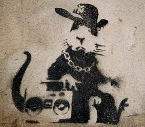 A photo of a work by graffiti artist Banksy depicting a rat with a boom box.