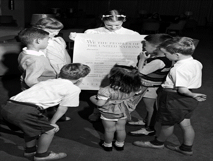 Children of UN delegates holding Preamble of the UN Charter. Details in text.