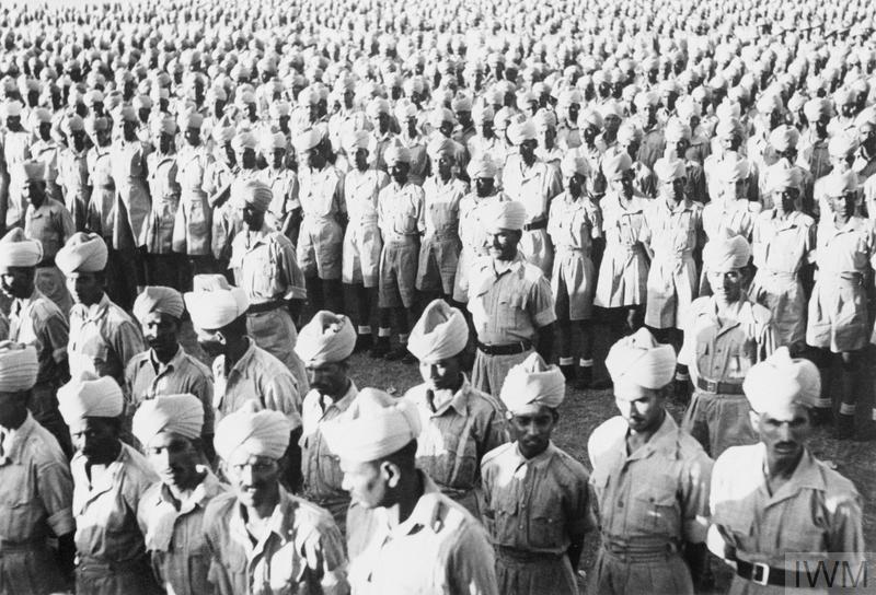 Rows of Indian soldiers in army uniforms and turbans. Millions of Indian soldiers were recruited to fight for the British in critical battles during World War II. Details in text.