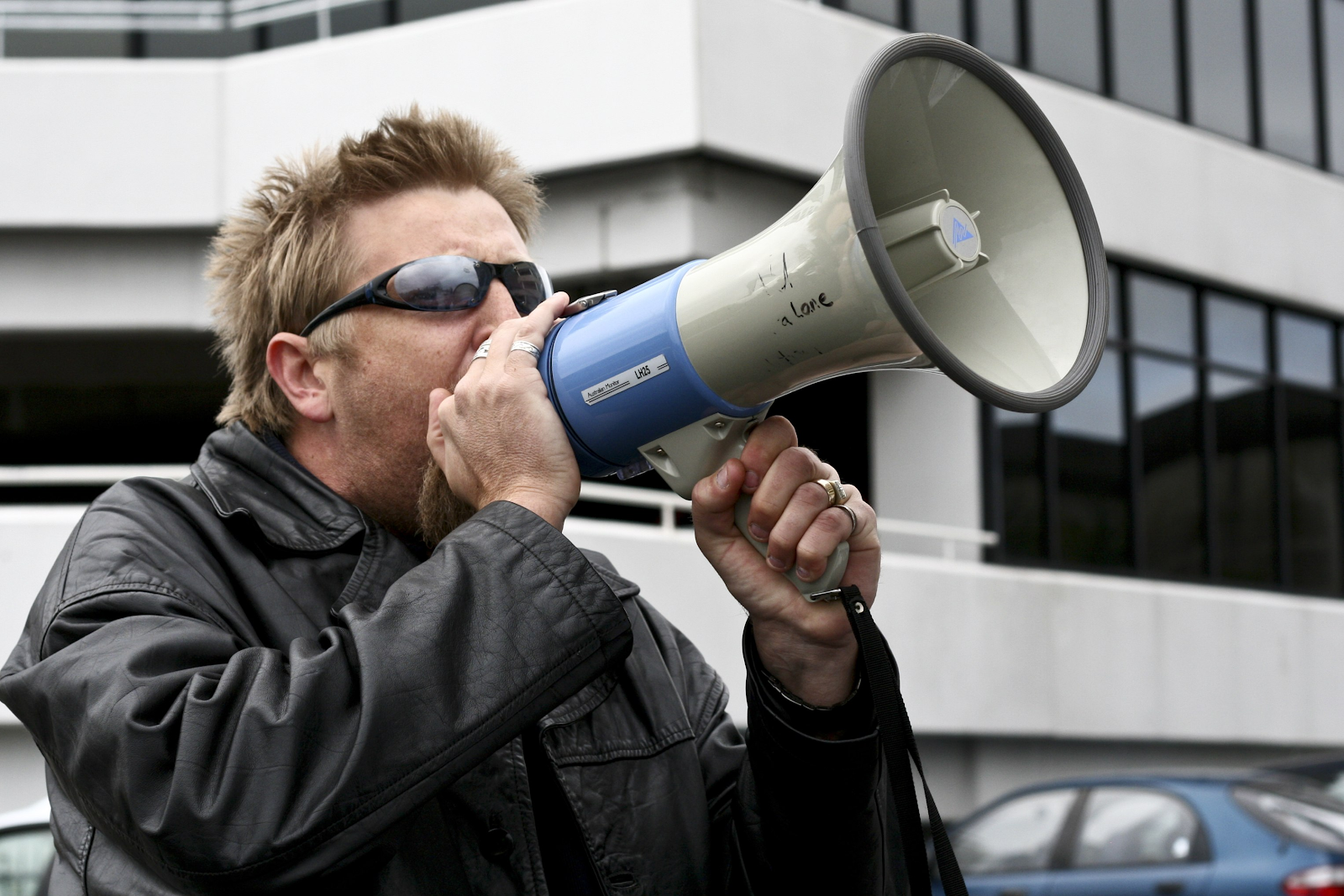 Image of a man yelling into a megaphone