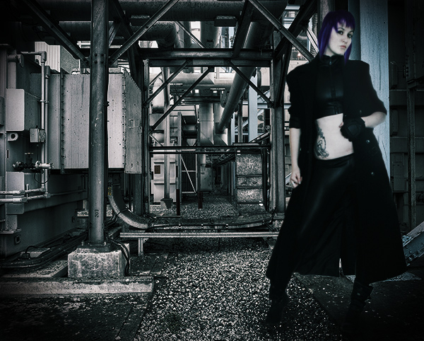 Image of girl in all black standing under pipes for  Ghost in the Shell cosplay
