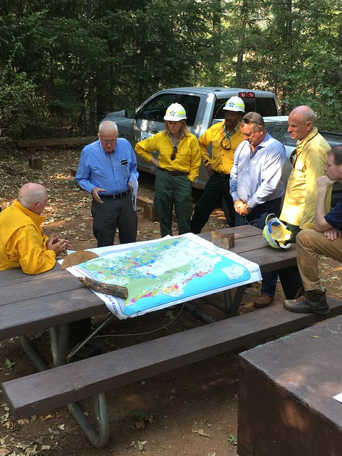USDA Forest Service officials and land owners discuss sharing stewardship of forests and future forest treatment strategies to recover lands. "Fire" by Pacific Southwest Region 5 is licensed under CC BY 4.0