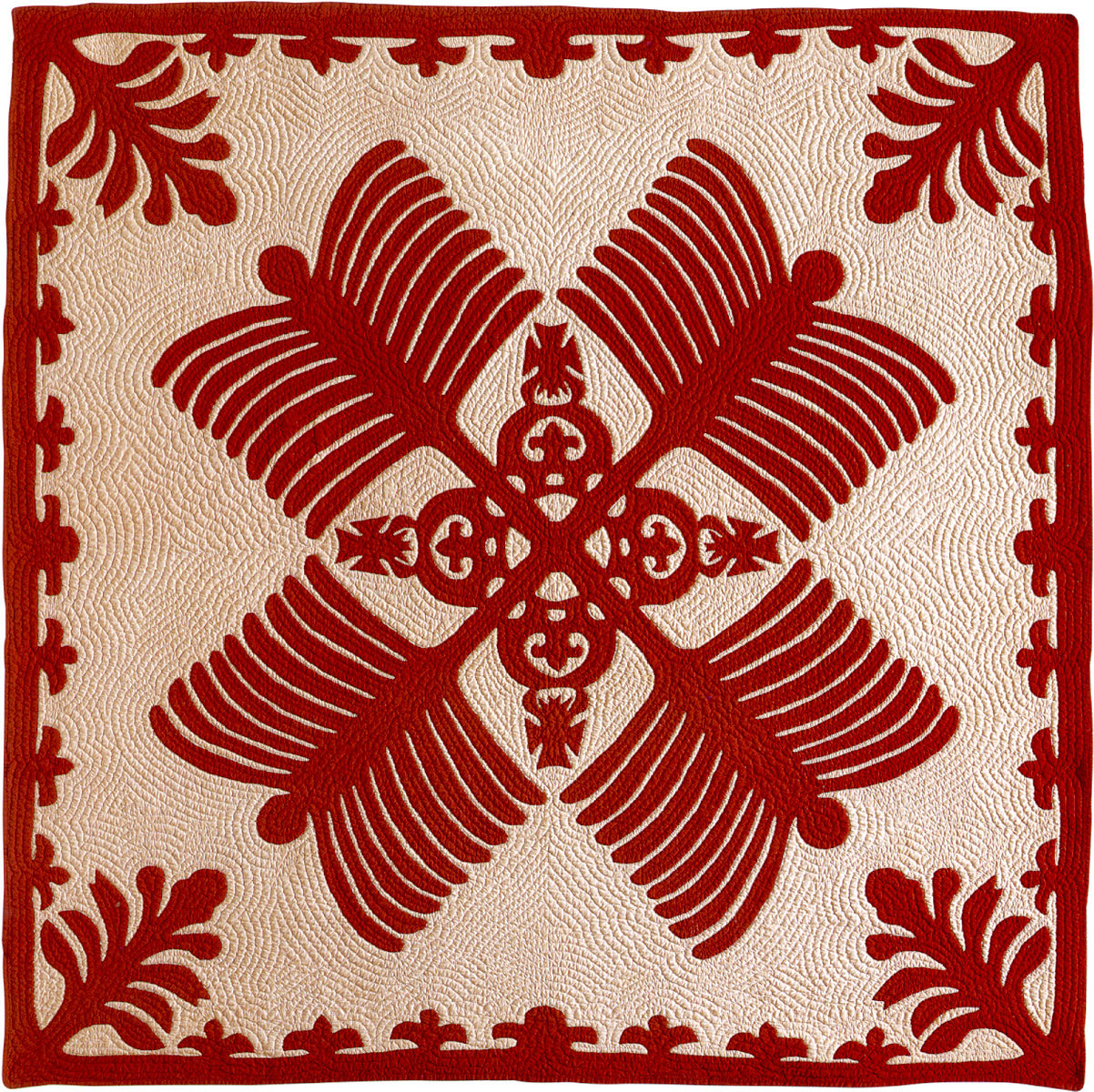 a quilt of red and white in a repeated pineapple pattern