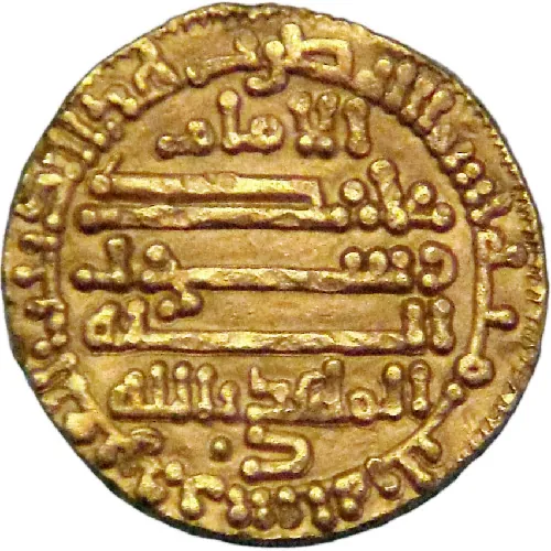 An image of a round gold coin is shown. The coin is uneven around the edges. Script is seen around the perimeter of the coin with raised writing. Inside the middle are six lines of script and long lines with raised writing.