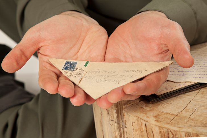 man holding an old letter