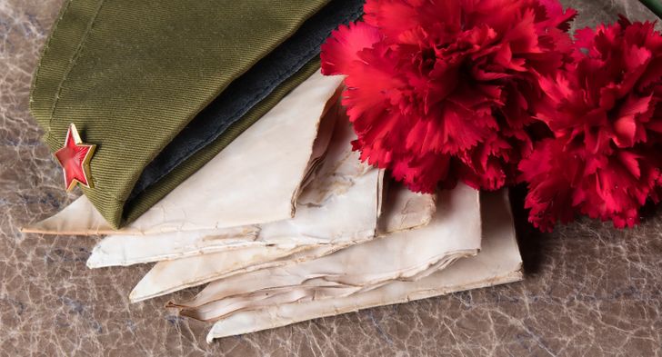 soldier's hat, letters, and flowers