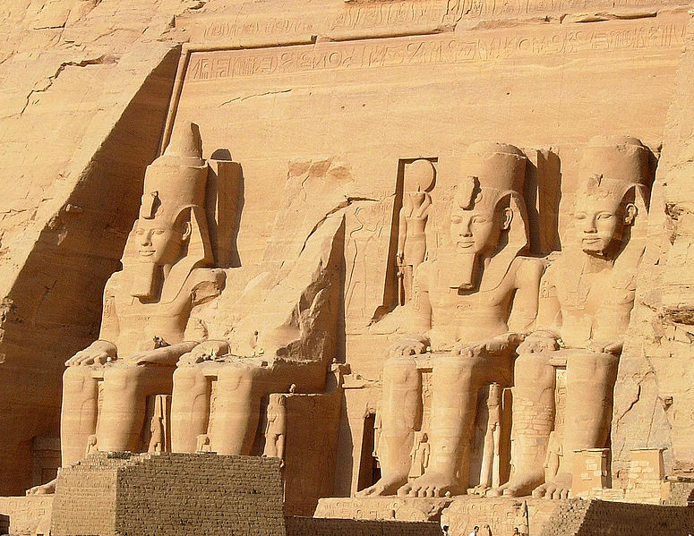 The entrance to Abu Simbel, with three huge statues of gods and one partially destroyed statue.