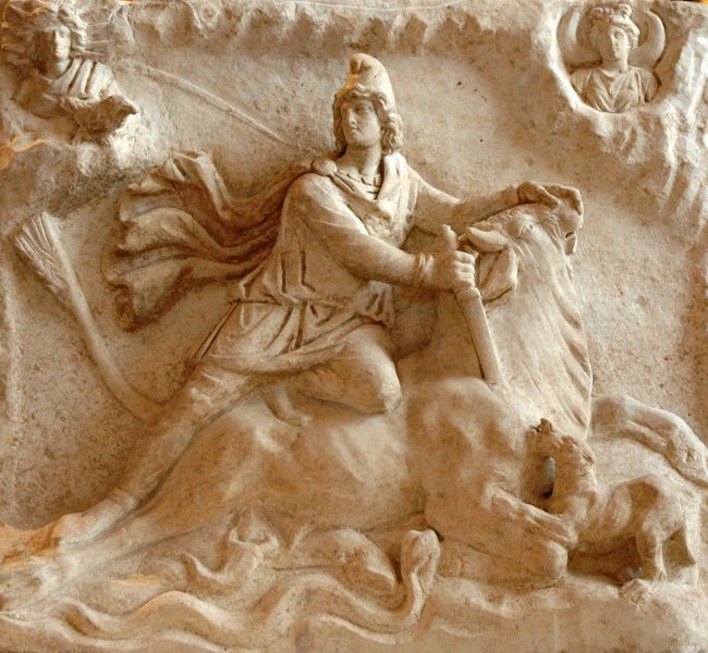 Stone carving of the demigod Mithras stabbing a bull.