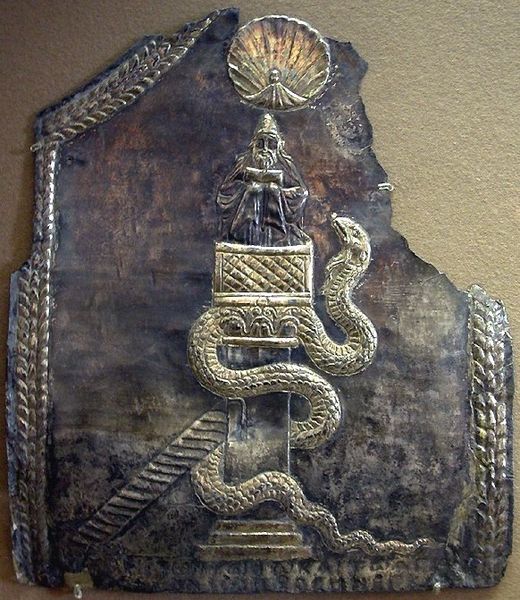 Brass relief of St. Simeon sitting on top of a pillar, with a shell symbolizing wisdom above his head and a serpent symbolizing temptation crawling up the pillar.