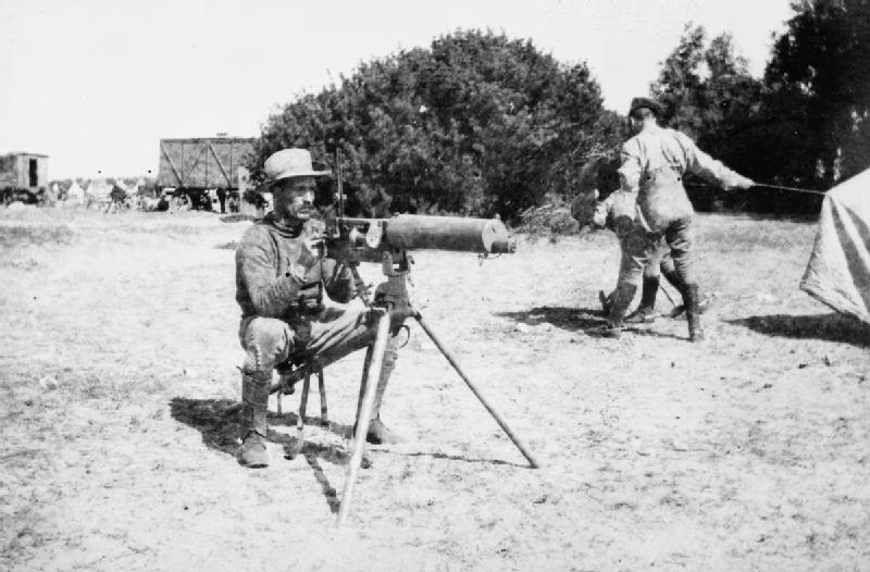British soldier aiming a maxim gun.