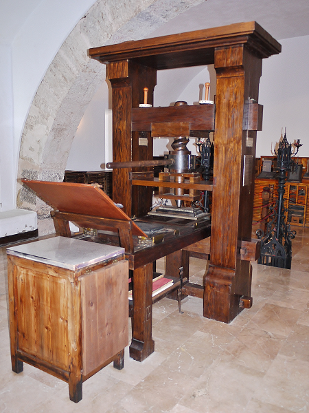 Replica of an early printing press made of wood.