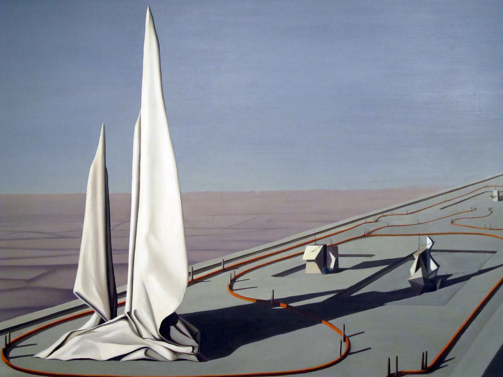 a large platform in a desert with large white sails