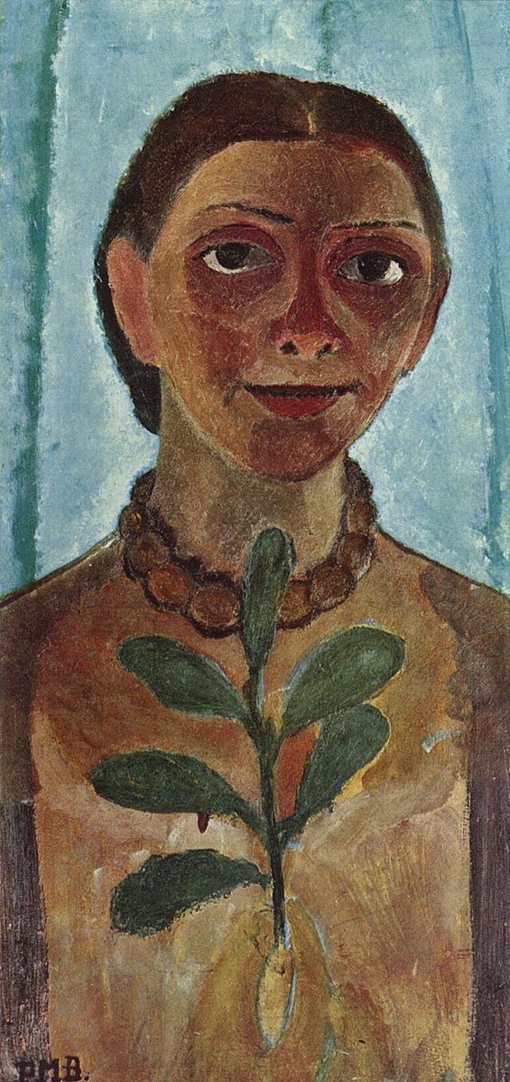 A woman with a beaded necklace and leaf