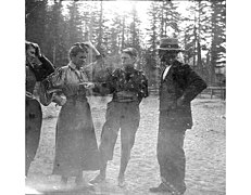 Three woman and a man at Longmire Springs, Mount Rainier, showing one woman wearing a pair of pants,
