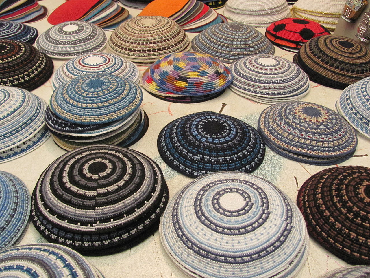 Handmade yarmulkes at a stand in the Old City of Jerusalem. Yarmulkes are described in text.