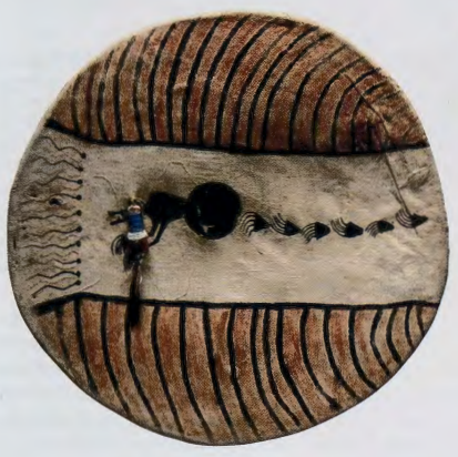 Figure 7.3: UNKNOWN ARTIST, Crow shield, Northern Plains, c. 1860. Rawhide, buckskin, wool, feather, pigment, 21 in (53.3 cm) diameter. Collection of Buffalo Bill Historical Center, Cody, Wyoming.