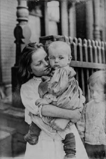 Figure 12.11: LEWIS HINE, Little Mother in the Steel District, Pittsburgh, 1909. Gelatin silver print, 6⅞ x 4⅞, in (17.3 x 12.5 cm).