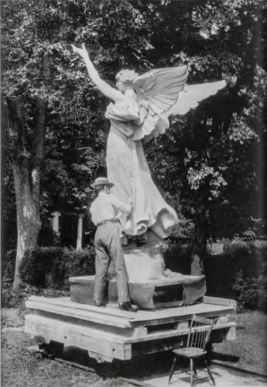 Figure 13.21: DANIEL CHESTER FRENCH, Large model in plaster, with the sculptor correcting a drapery fold, Chesterwood, 1914. Plaster. Chesterwood Archives, Chesterwood, Stockbridge, Massachusetts.