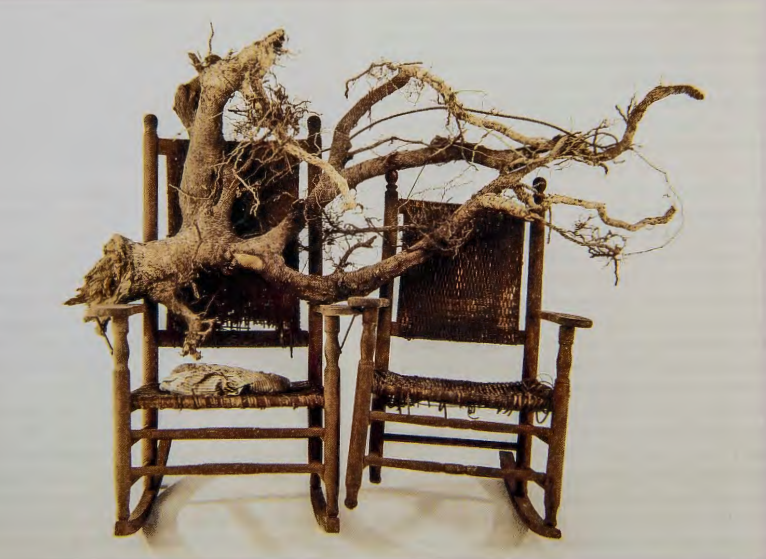 Figure 15.27: LONNIE HOLLEY, Him and Her Hold the Root, 1994. Rocking chairs, pillow, root, 45½ X 73 X 30½ in (115.5 X 185 X 77.4 cm). Private collection.