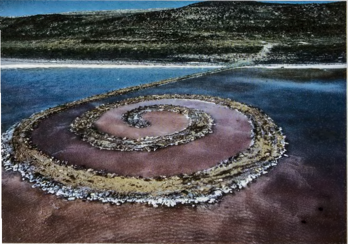 Figure 18.30: ROBERT SMITHSON, Spiral Jetty, Great Salt Lake, Utah, 1970. Black rock, salt crystals, earth, and red water (algae), 4 x 15 x 1500 ft (1.21 X 4.57 X 457.2 m).