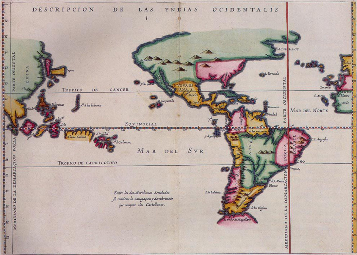 A historical map shows South and North America, Europe on the right and China on the left. Locations are labeled. Mountains are indicated on the land and rivers are drawn. A red line labeled Eqvinocial crosses horizontally through the top portion of South America, cutting the map in half. Another red line runs vertically in the right fifth of the map, running through a bit of North America and the very eastern portion of South America. The lines intersect on the north coast of Brazil. Words at the top read: Descripcion de las Yndias Ocidentalis.”