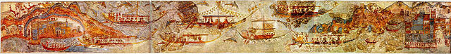 This is a color photograph of the fresco, which depicts eight large ships and three smaller vessels, all powered by men with oars. They appear to be traveling from one port to another.