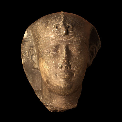Bronze-colored bust depicts a man's face.