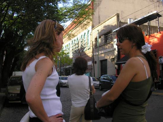 three women arguing on the sidewalk