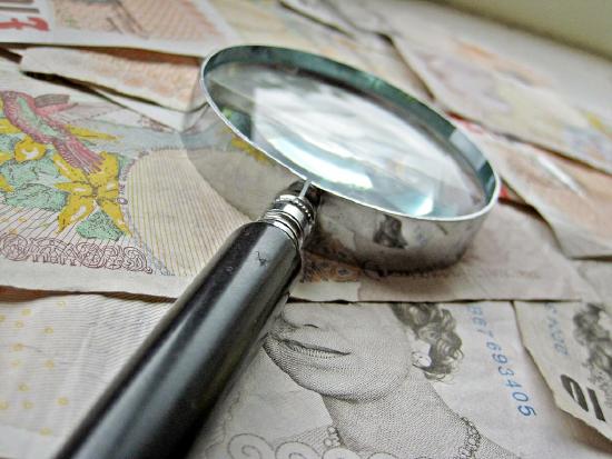 British Money and magnify glass