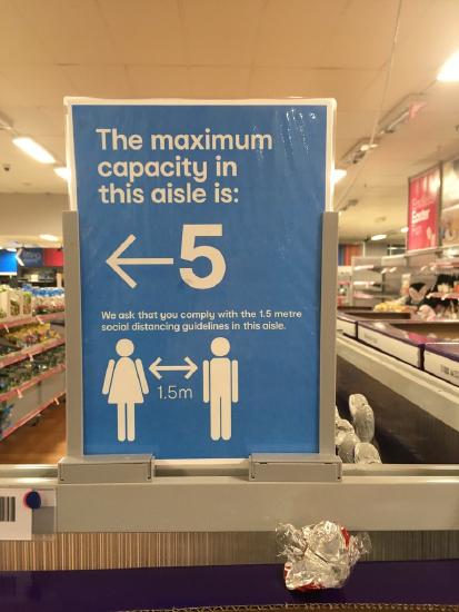 Aisle capacity signs due to COVID-19 coronavirus pandemic inside Kmart at Northcote Plaza