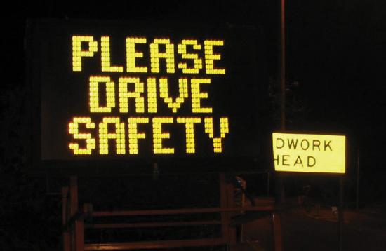 A lit up road sign saying