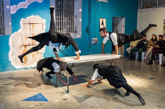 A group of people doing a trick on a tableDescription automatically generated