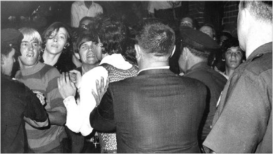 Crowd trying to impede police raid of Stonewall Inn Nightclub in 1969