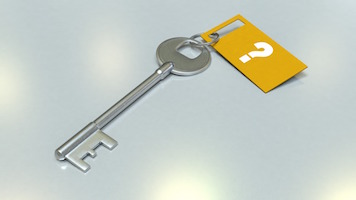 A key with a tag attached.  The tag shows a question mark.