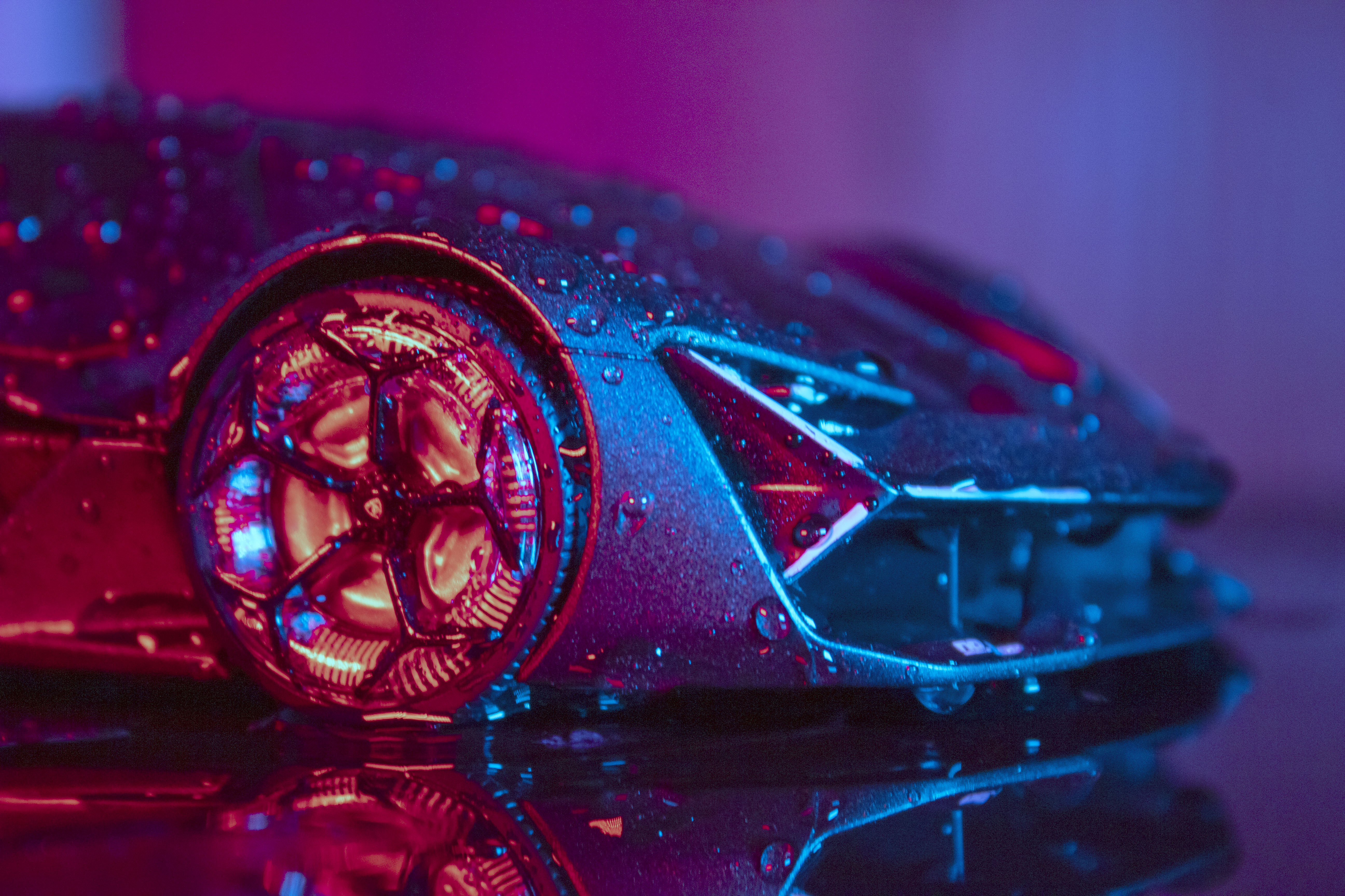 close up of a metallic toy car with water drops