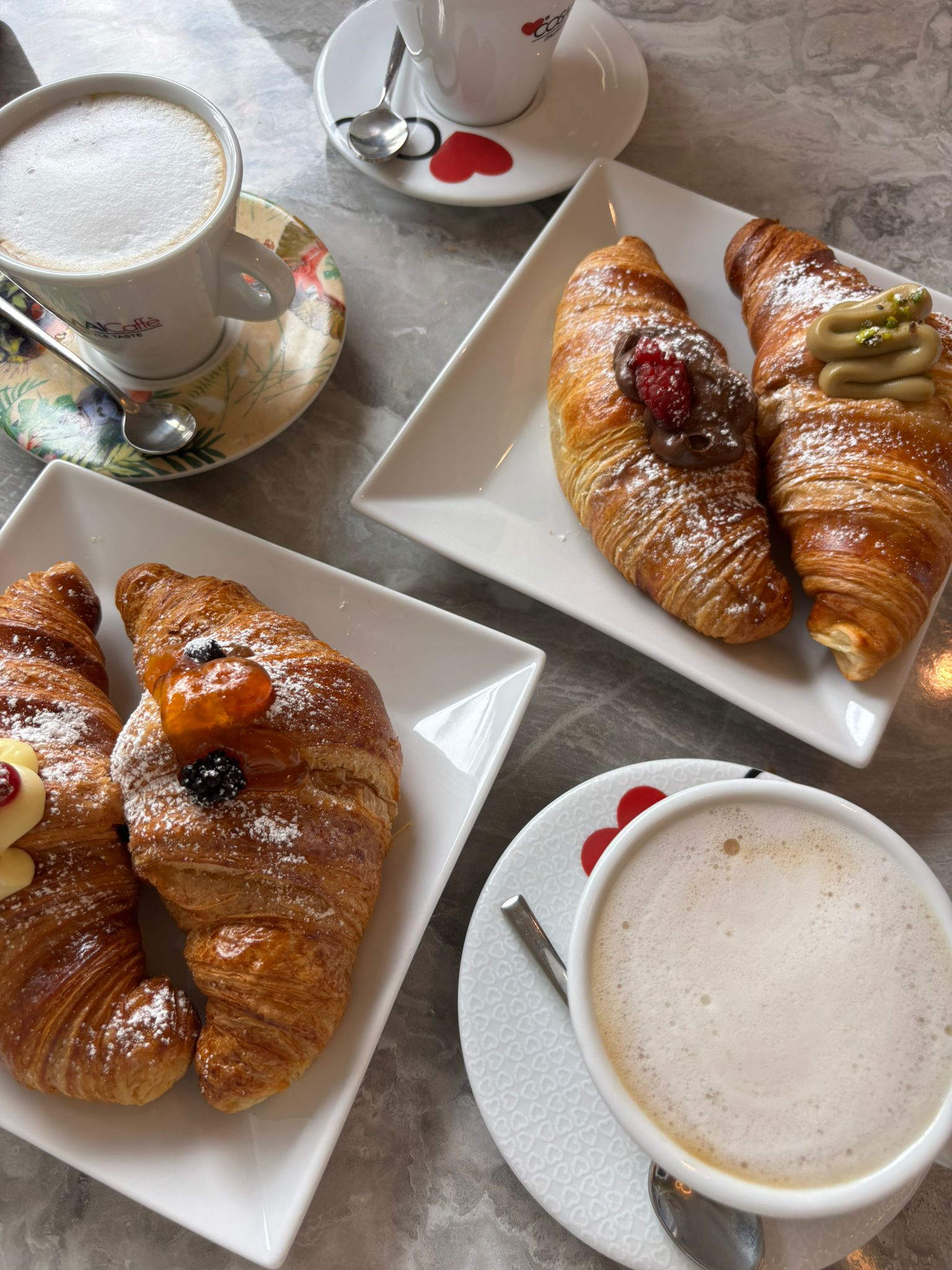 A sweet break: one espresso, two cappuccinos, four croissants.