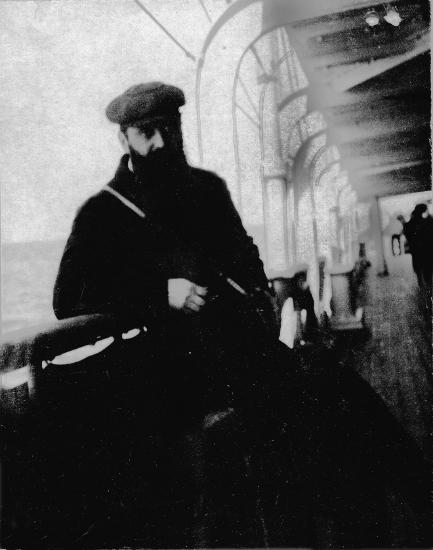 A bearded man wearing a cap on board a ship. Details in text.