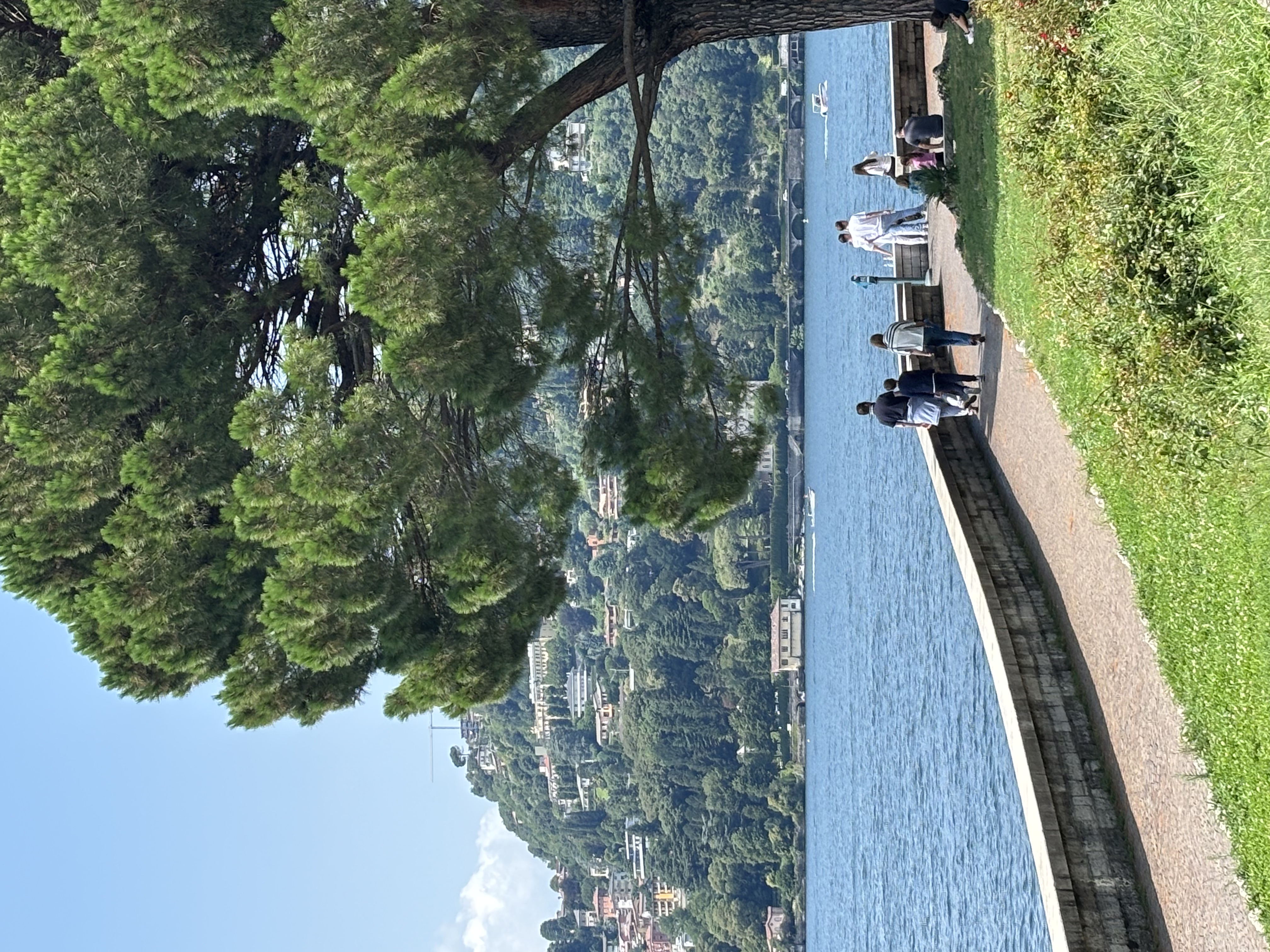 Lakefront promenade in Como with the lake and mountains in the background.