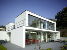 modern house exterior, with white walls and floor-to-ceiling windows